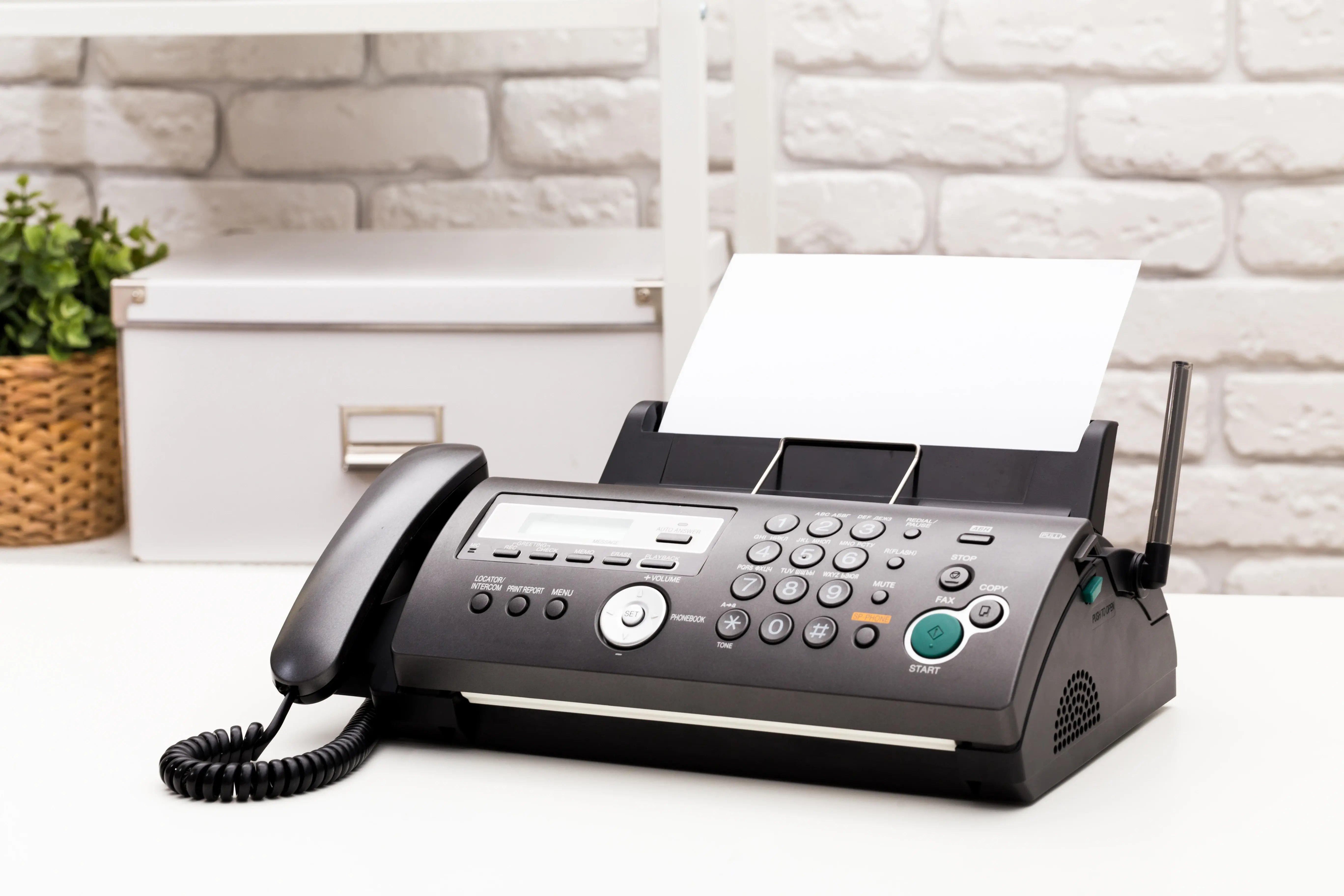 black-office-fax-machine-with-paper-inside-2026-01-08-22-52-12-utc