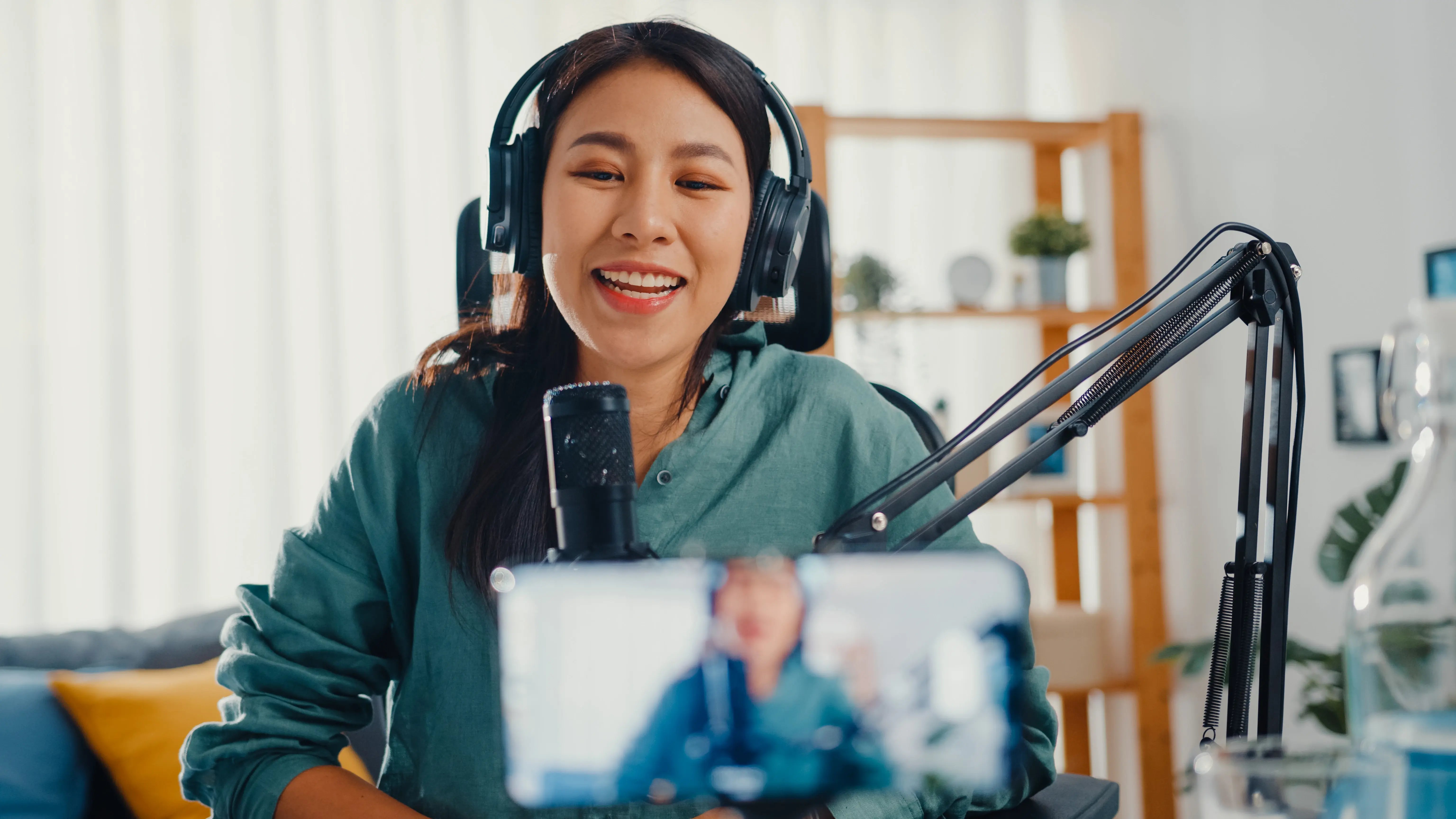 enthusiastic-young-woman-recording-podcast-at-home-2026-01-05-23-26-25-utc