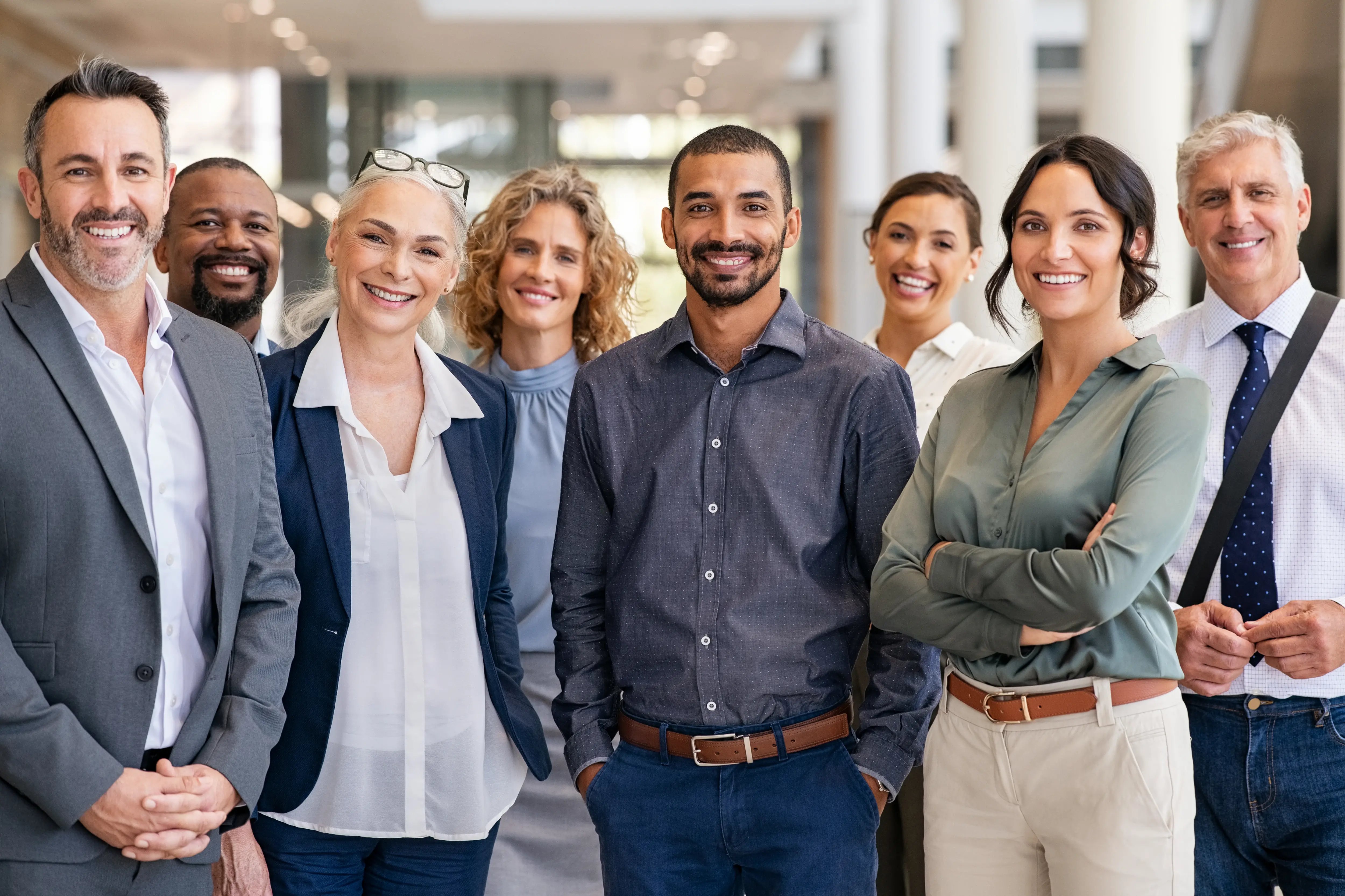 smiling-professionals-standing-together-in-a-brigh-2026-01-06-10-54-37-utc