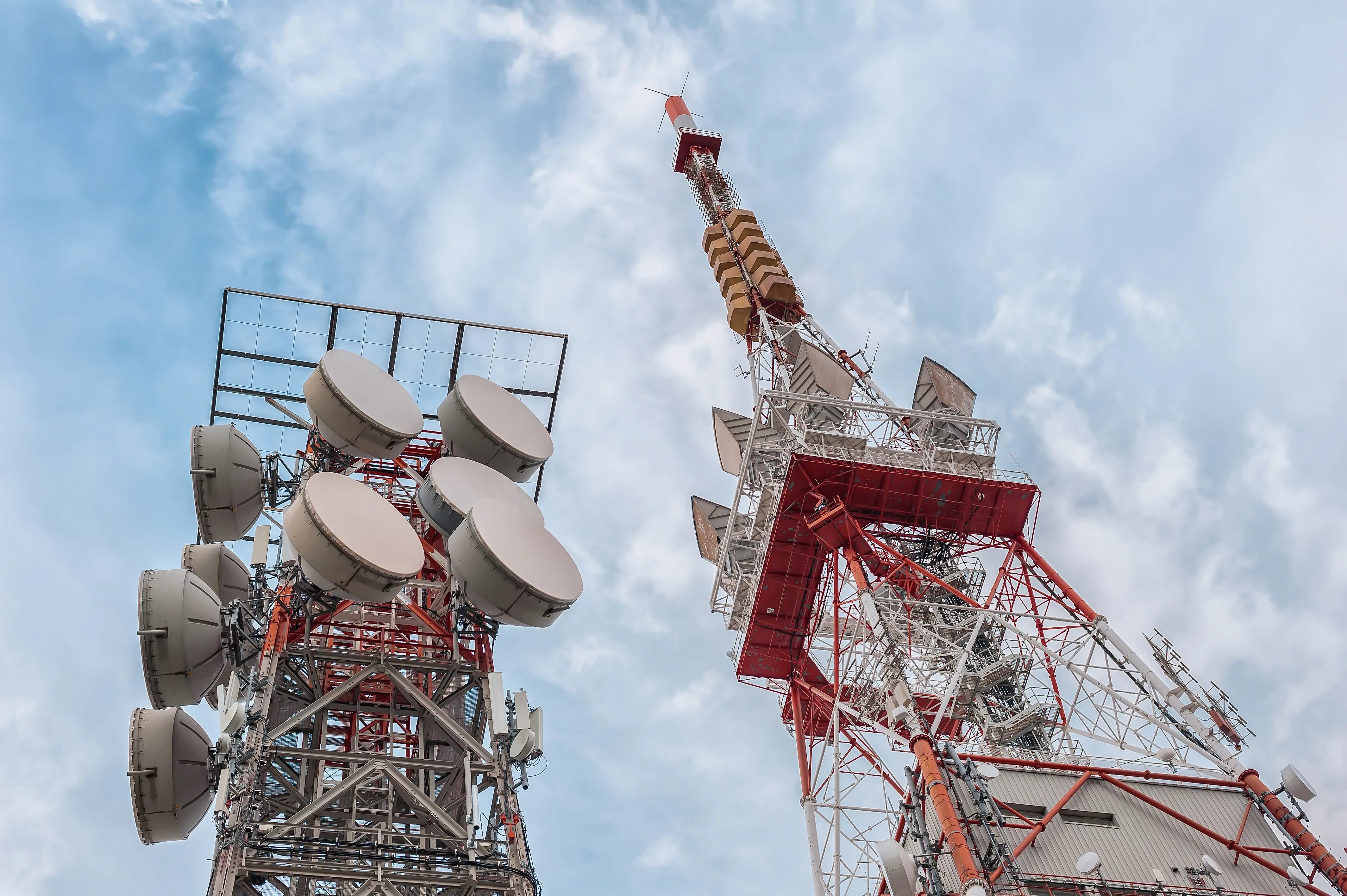 tall-communication-towers-against-cloudy-blue-sky-2026-03-17-00-00-29-utc